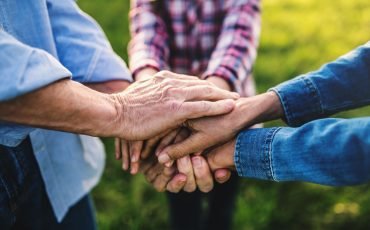 hands-of-small-girl-and-her-senior-grandparents-EKH9UTX.jpg